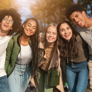 Group portrait of happy multiracial teenaged friends outdoors